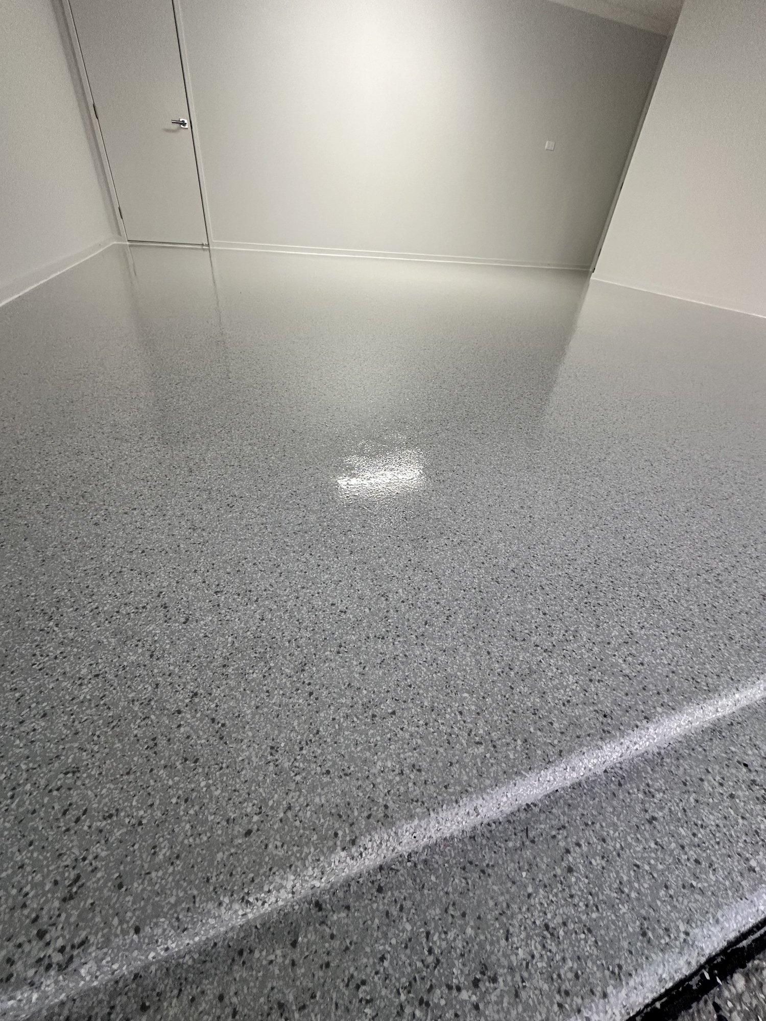 Close up of pebble blend epoxy flake garage floor coating